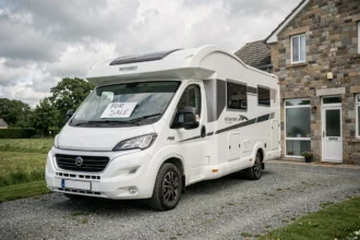 Camping-car à vendre devant une étude notariale, illustrant une vente suite à un décès ou divorce